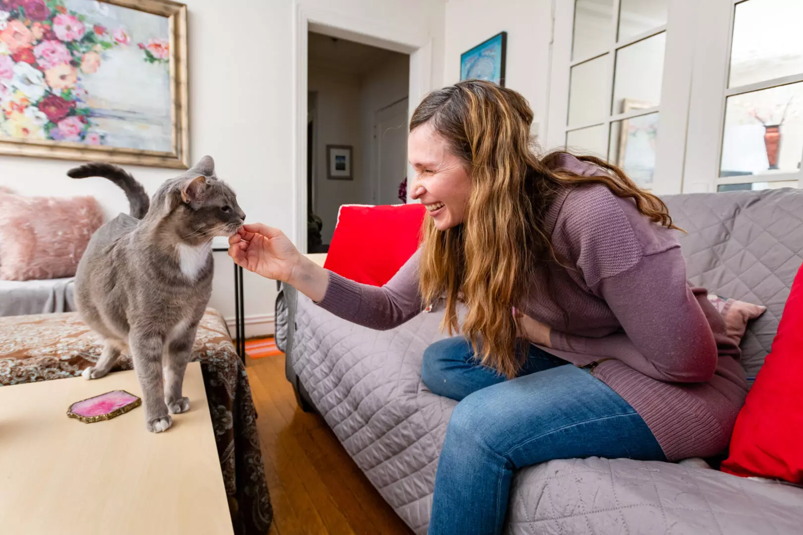 Pet sitter showing affection to cat.